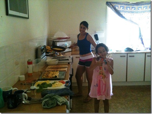 Sanna and Basma cooking omelettes in the kitchen for everyone.